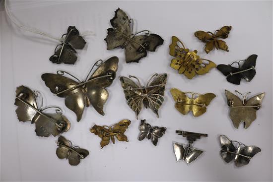 Fourteen assorted butterfly brooches including silver and enamel and filligree and a butterfly earclip.